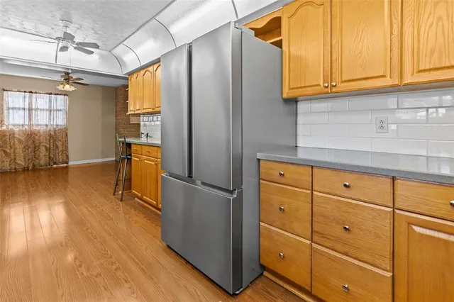 a kitchen with stainless steel appliances granite countertop a sink a stove cabinets counter space and wooden floor