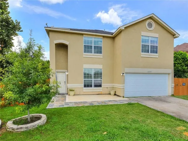 a front view of house with yard and green space