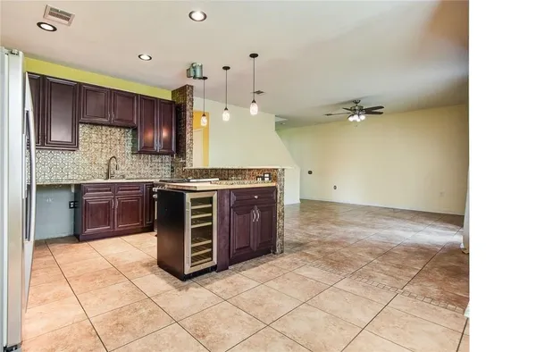 a kitchen with stainless steel appliances a stove a sink and a refrigerator