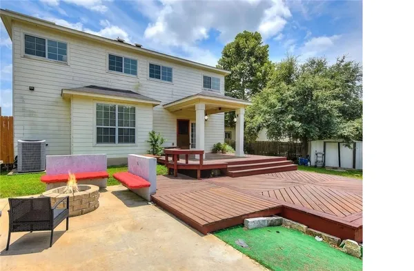a view of a house with a couches chair and grass