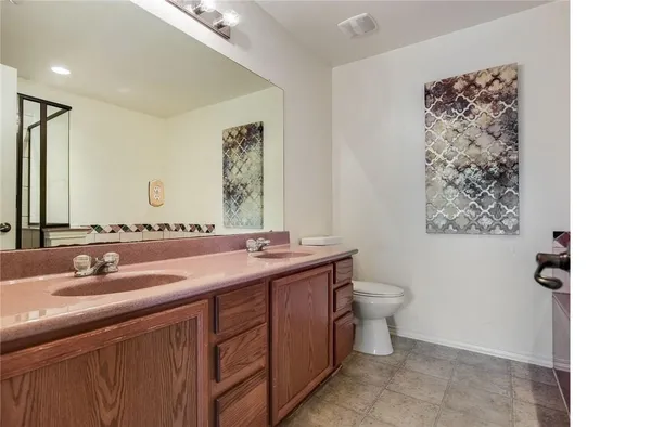 a bathroom with a toilet sink and mirror