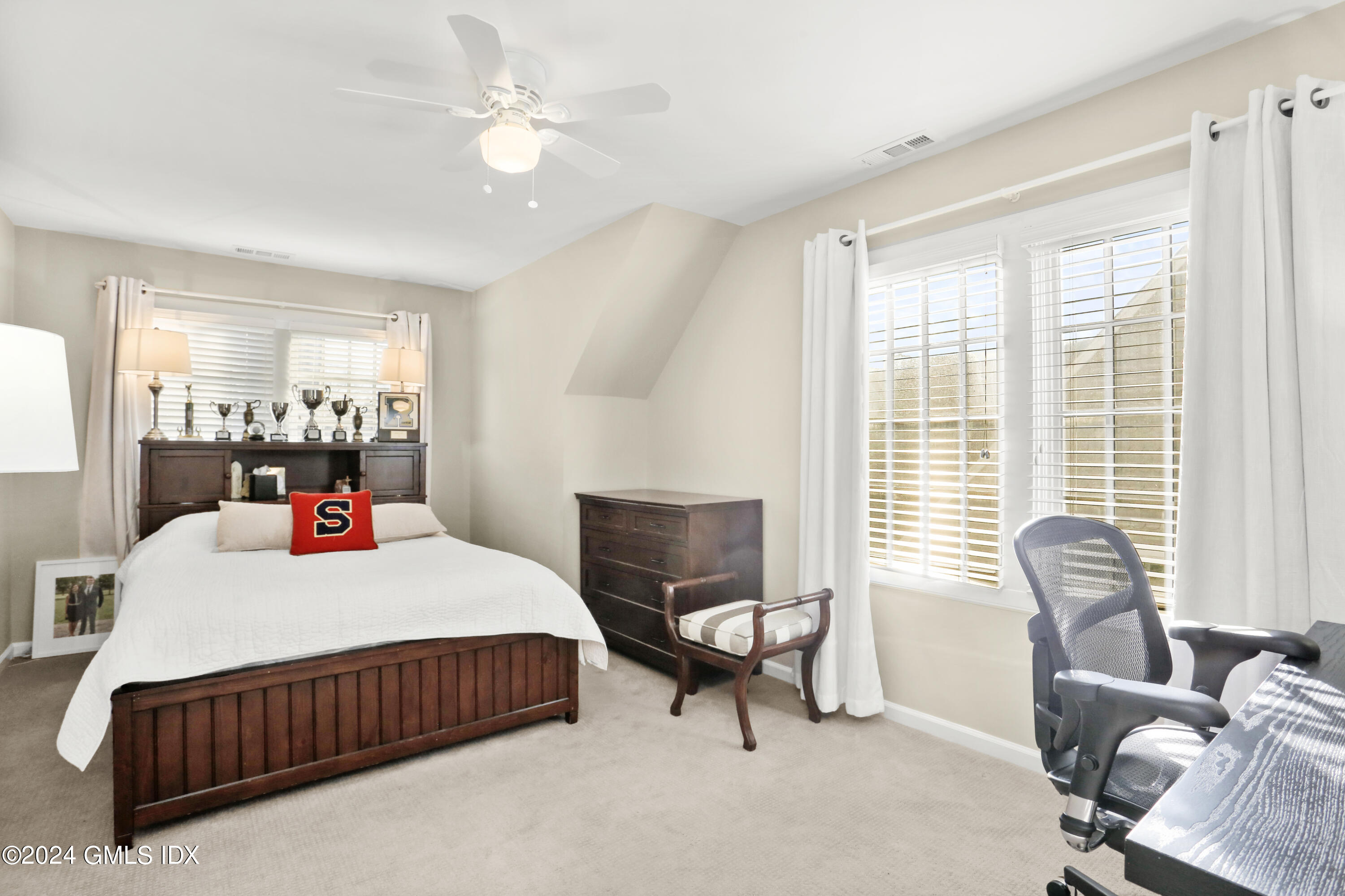 186 Field Point Road, Unit 6A Greenwich, CT 06830 - Photo 11 of 32 a bedroom with a bed and a dresser with mirror