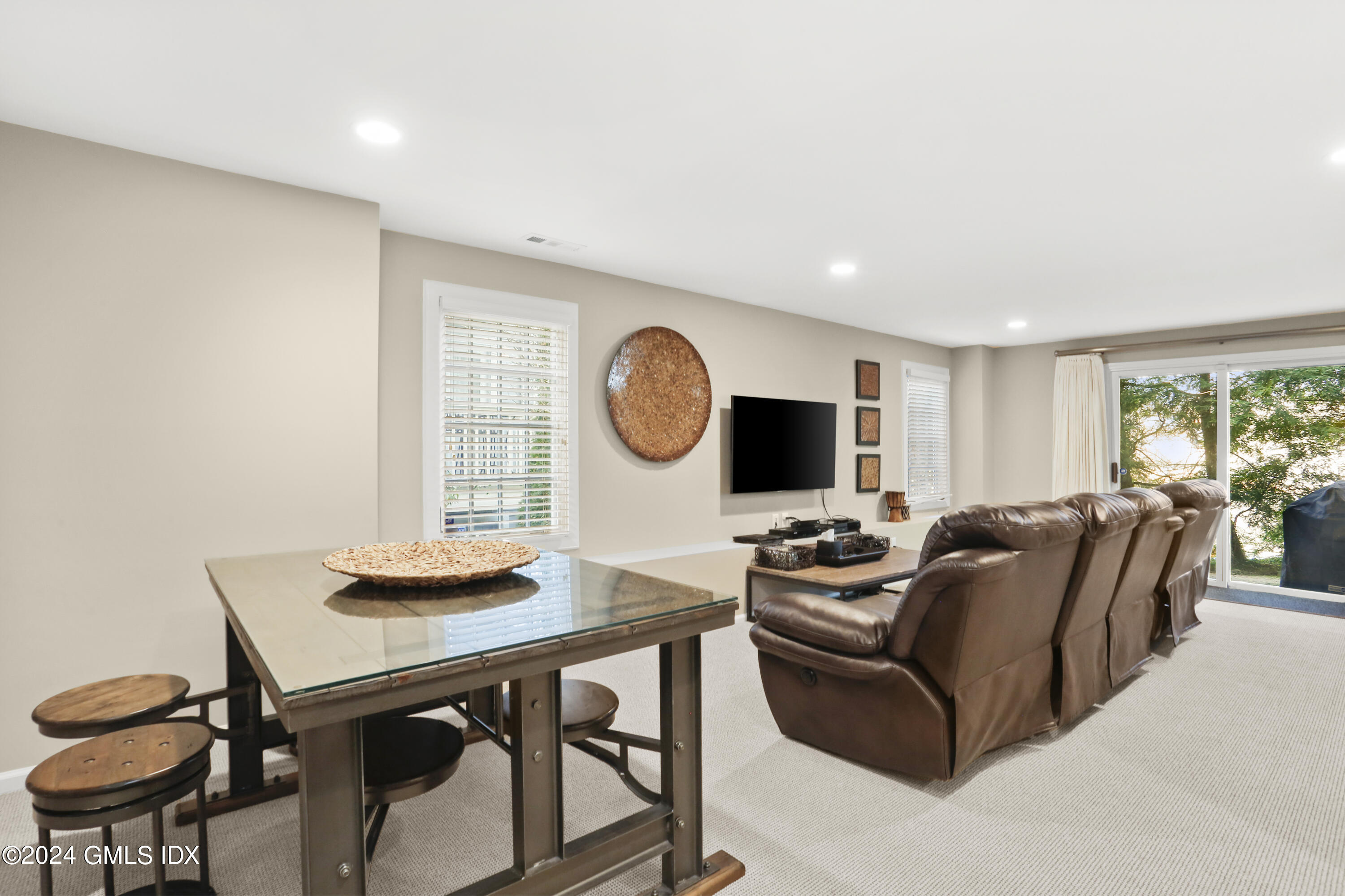 186 Field Point Road, Unit 6A Greenwich, CT 06830 - Photo 21 of 32 a living room with furniture a window and a flat screen tv