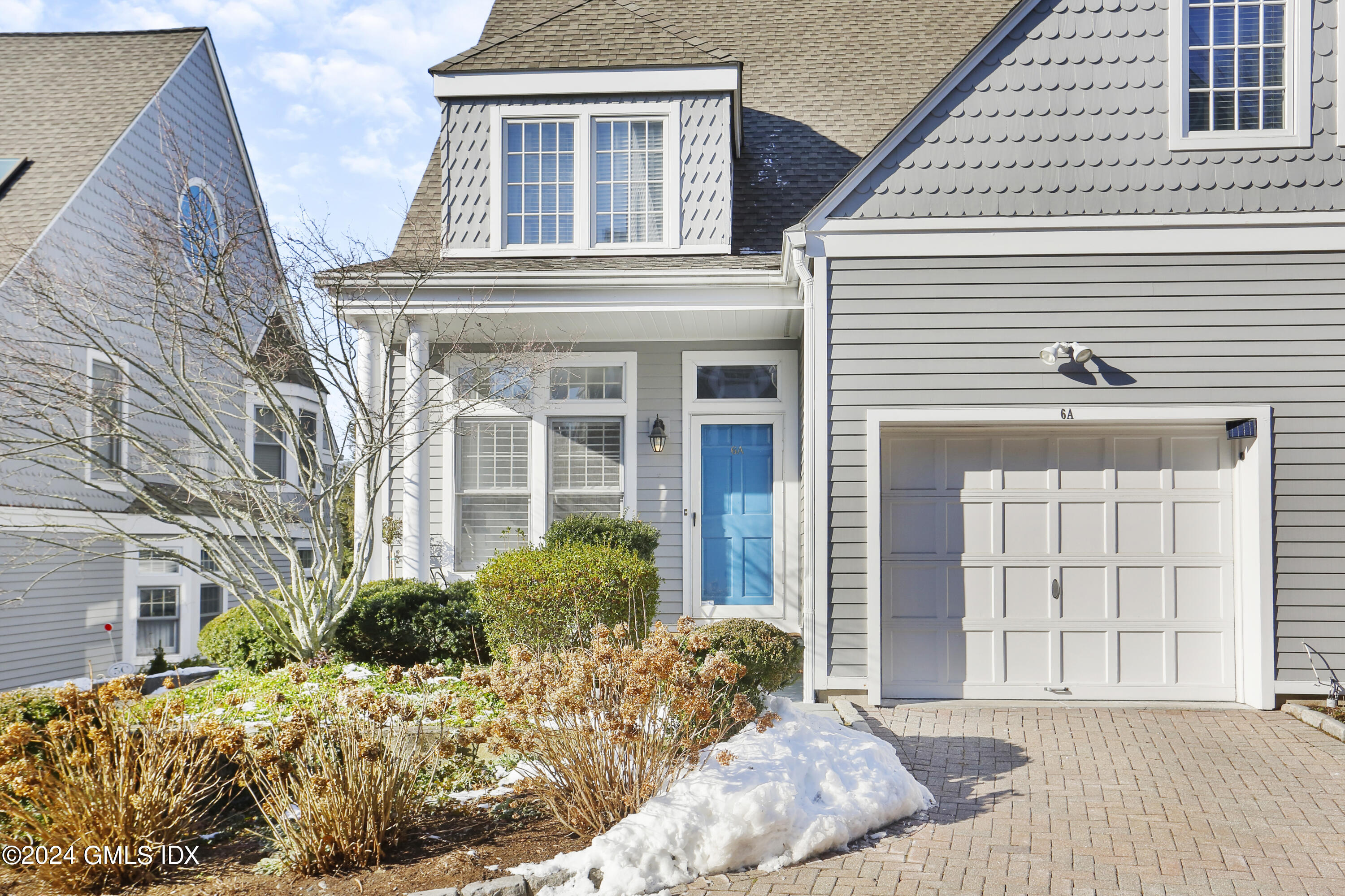 186 Field Point Road, Unit 6A Greenwich, CT 06830 - Photo 28 of 32 a front view of a house with a yard