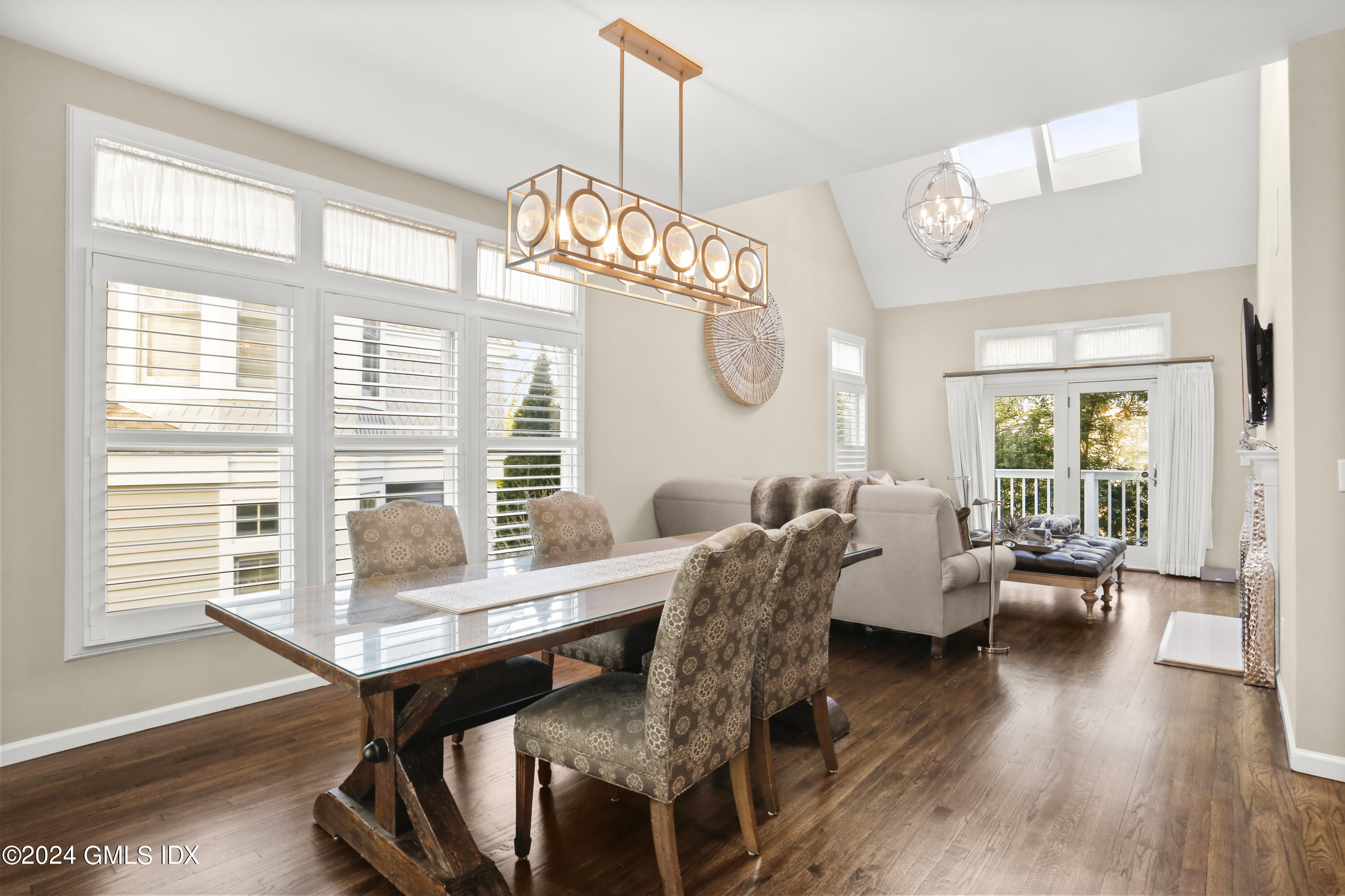 186 Field Point Road, Unit 6A Greenwich, CT 06830 - Photo 3 of 32 a view of a dining room with furniture window and wooden floor