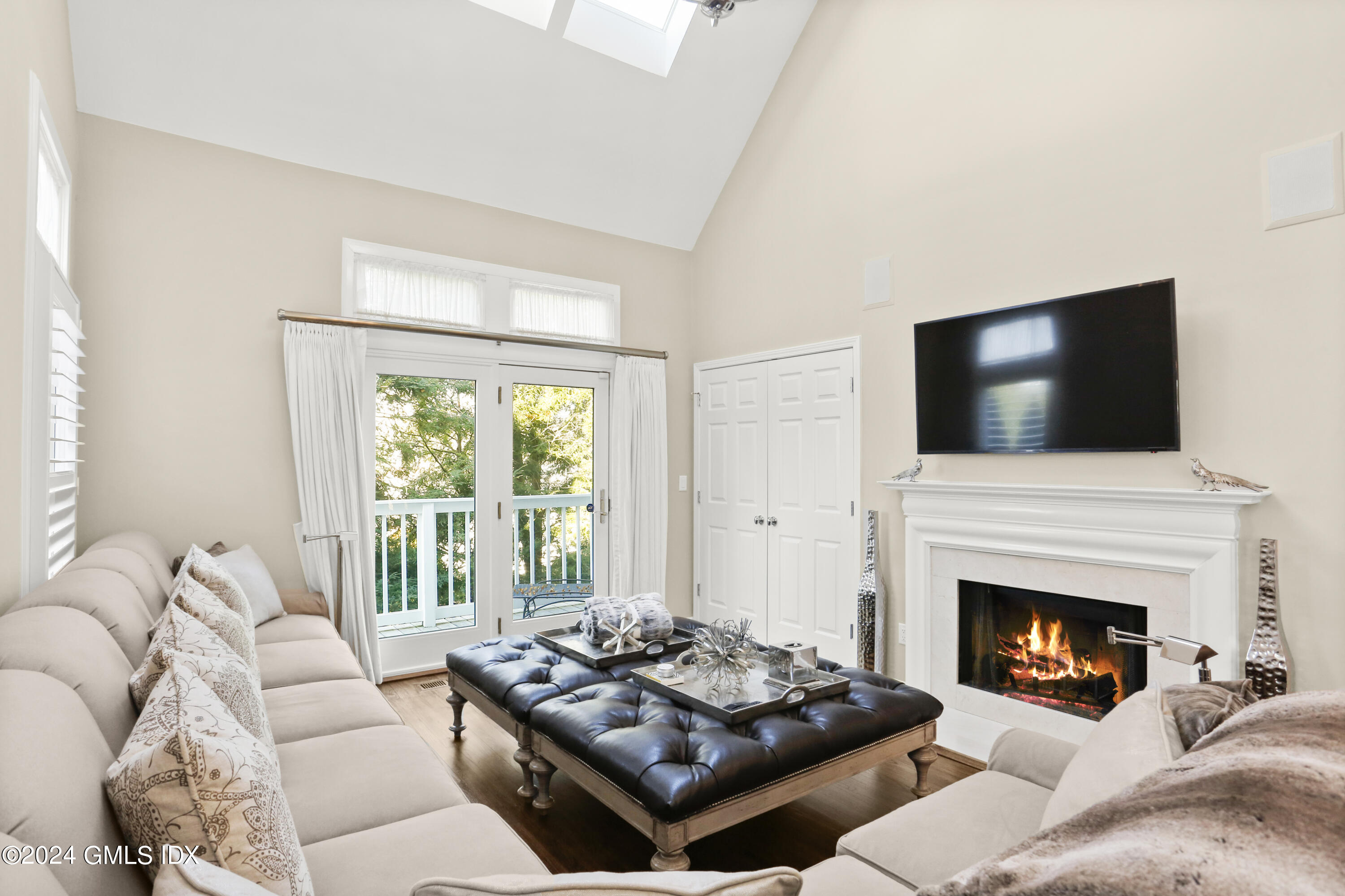 186 Field Point Road, Unit 6A Greenwich, CT 06830 - Photo 6 of 32 a living room with furniture a flat screen tv and a fireplace