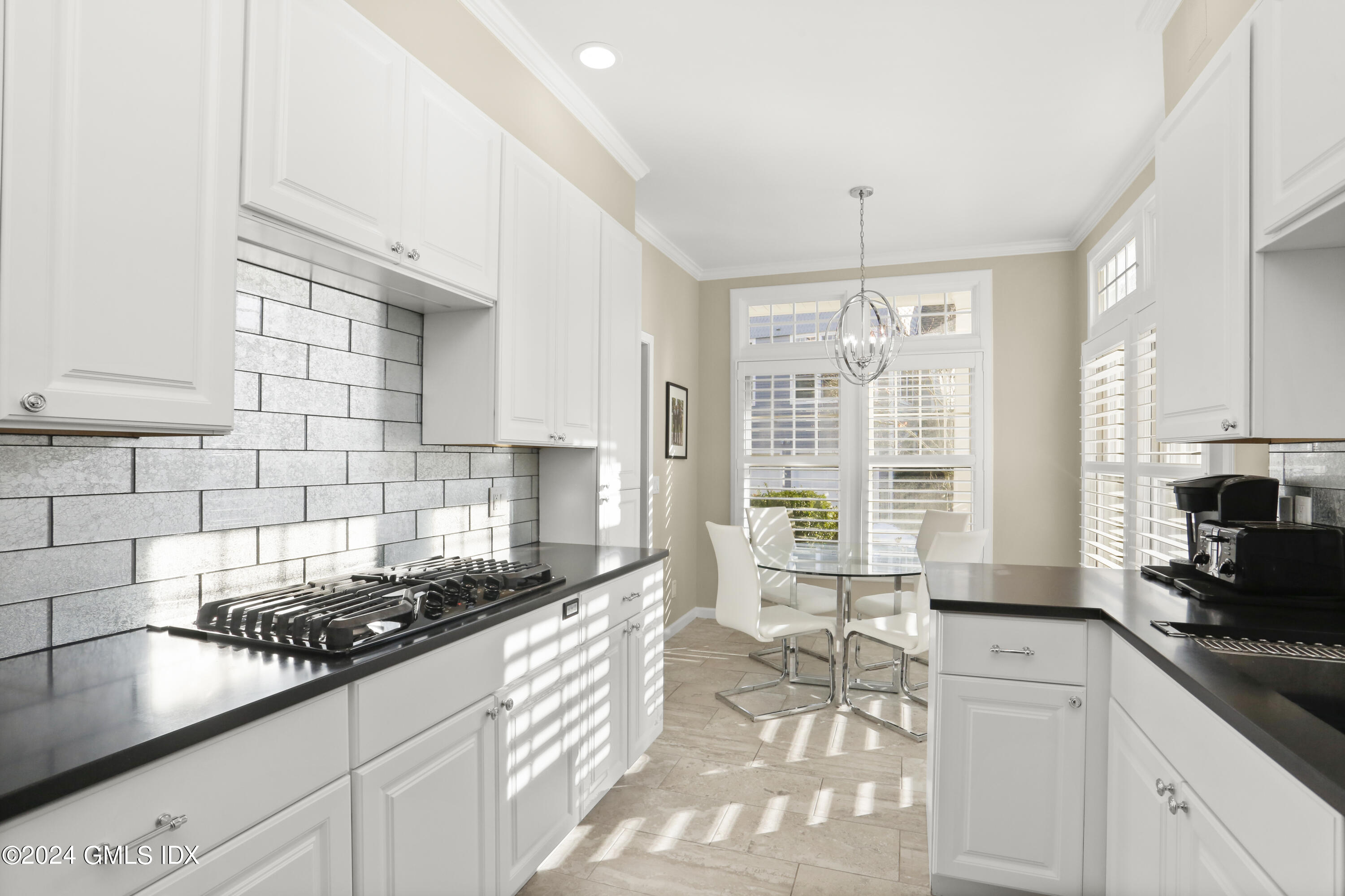 186 Field Point Road, Unit 6A Greenwich, CT 06830 - Photo 7 of 32 a kitchen with sink a stove and cabinets