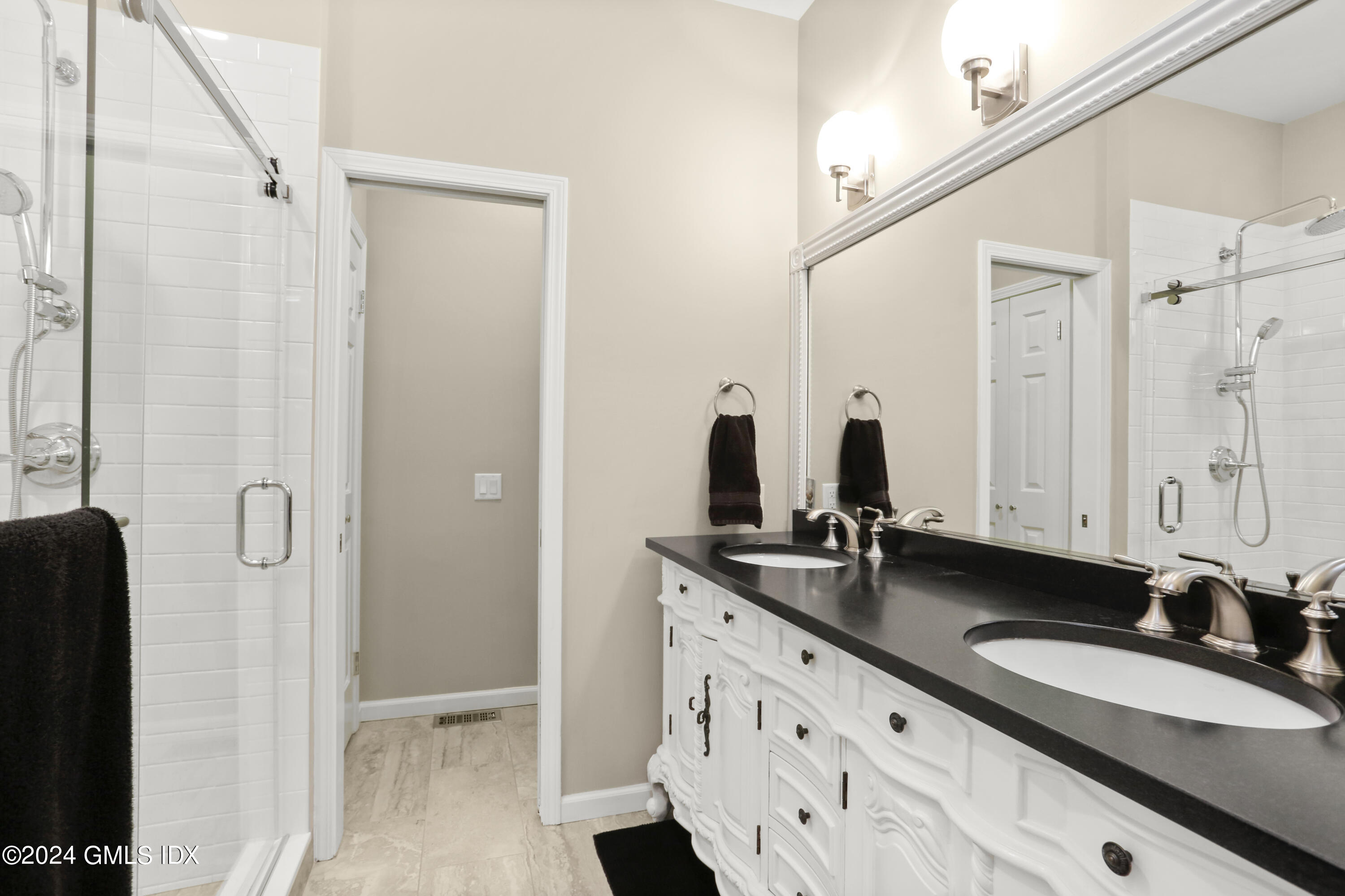 186 Field Point Road, Unit 6A Greenwich, CT 06830 - Photo 10 of 32 a bathroom with double sink and a mirror