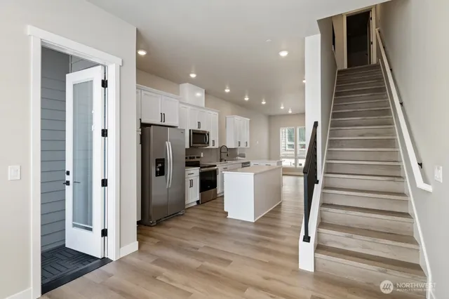 a view of kitchen with refrigerator microwave and stove