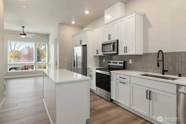 a kitchen with a sink stove and refrigerator