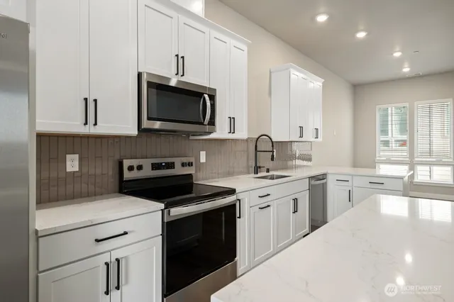 a kitchen with a sink stove and microwave