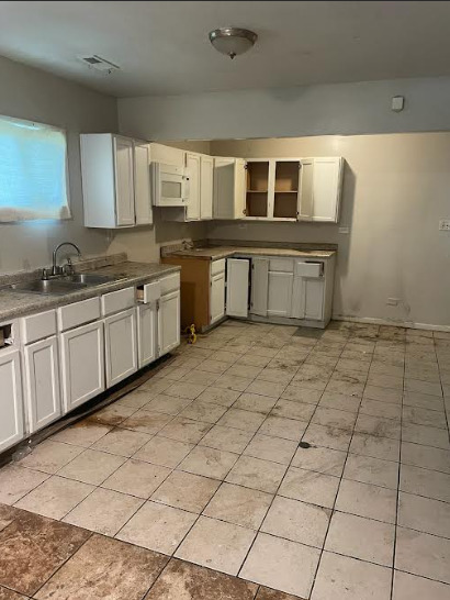 16516 Turner Avenue Markham, IL 60428 - Photo 2 of 3 a large white kitchen with kitchen island granite countertop a black white checkered floor