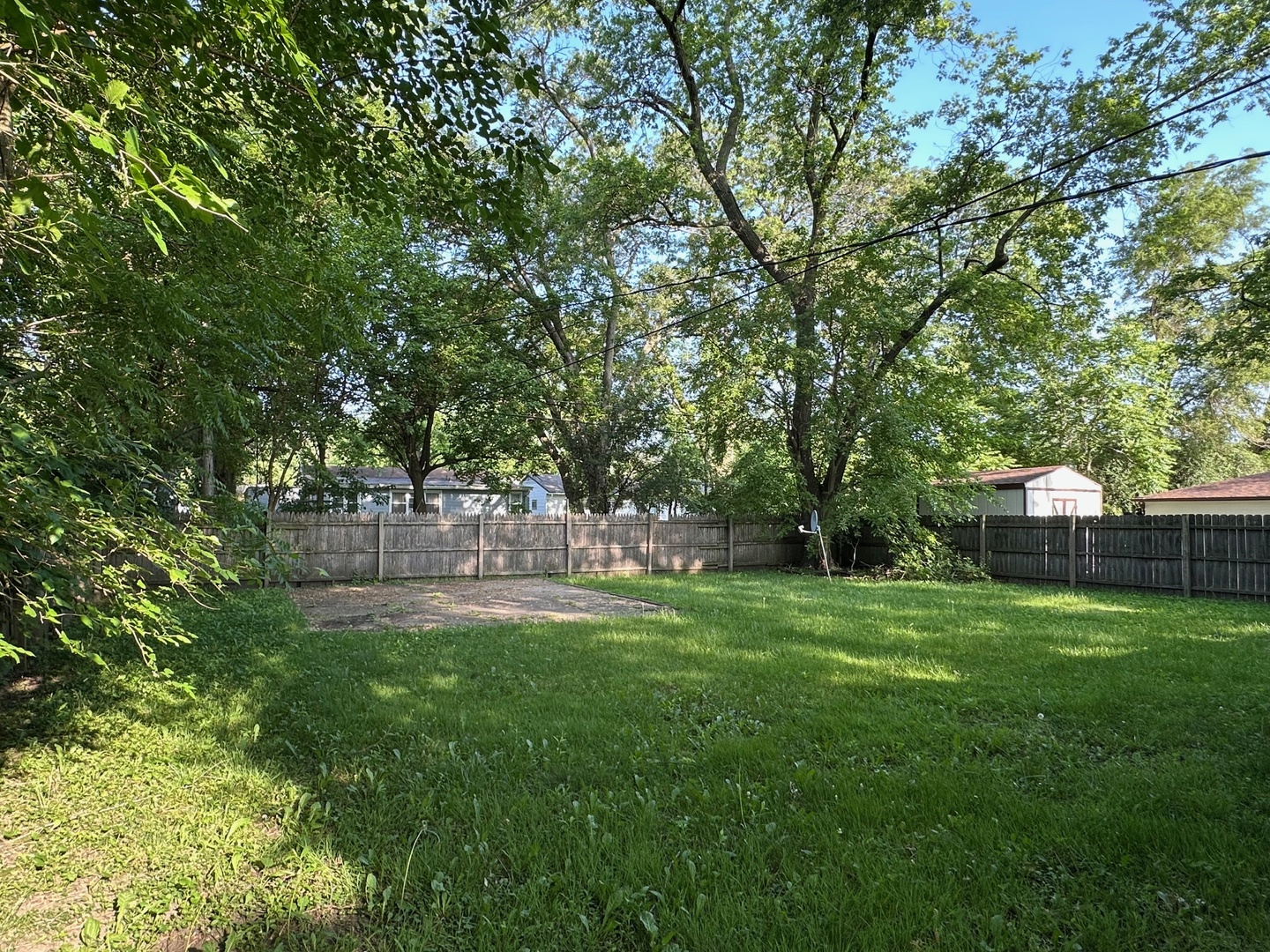 16516 Turner Avenue Markham, IL 60428 - Photo 3 of 3 a backyard of a house with table and chairs