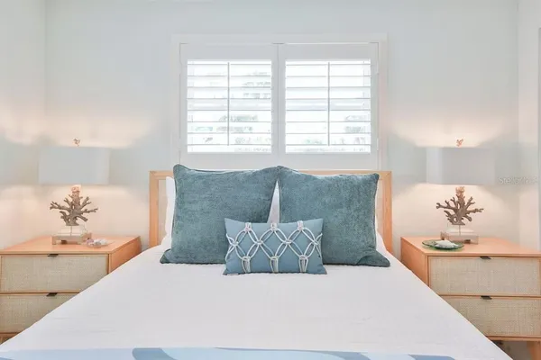 a spacious bedroom with a bed and a cabinets
