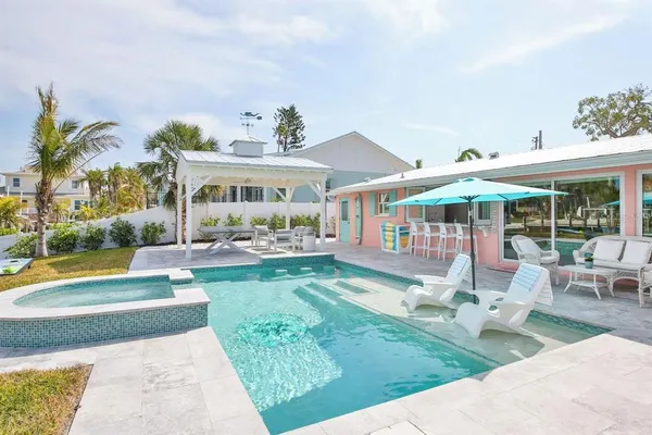 a view of swimming pool with outdoor seating
