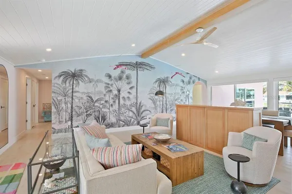 a living room with furniture and potted plants