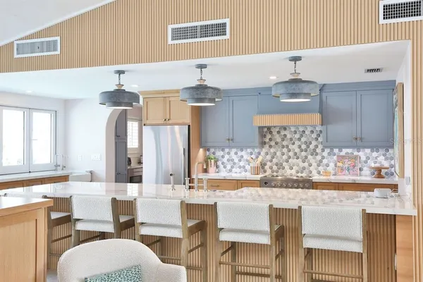 a kitchen with stainless steel appliances granite countertop a stove and cabinets