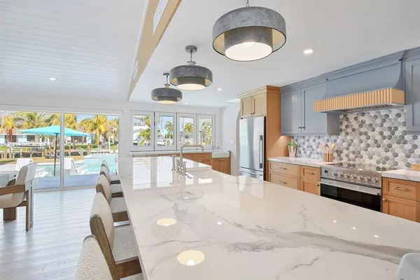 a kitchen with stainless steel appliances granite countertop a sink and cabinets