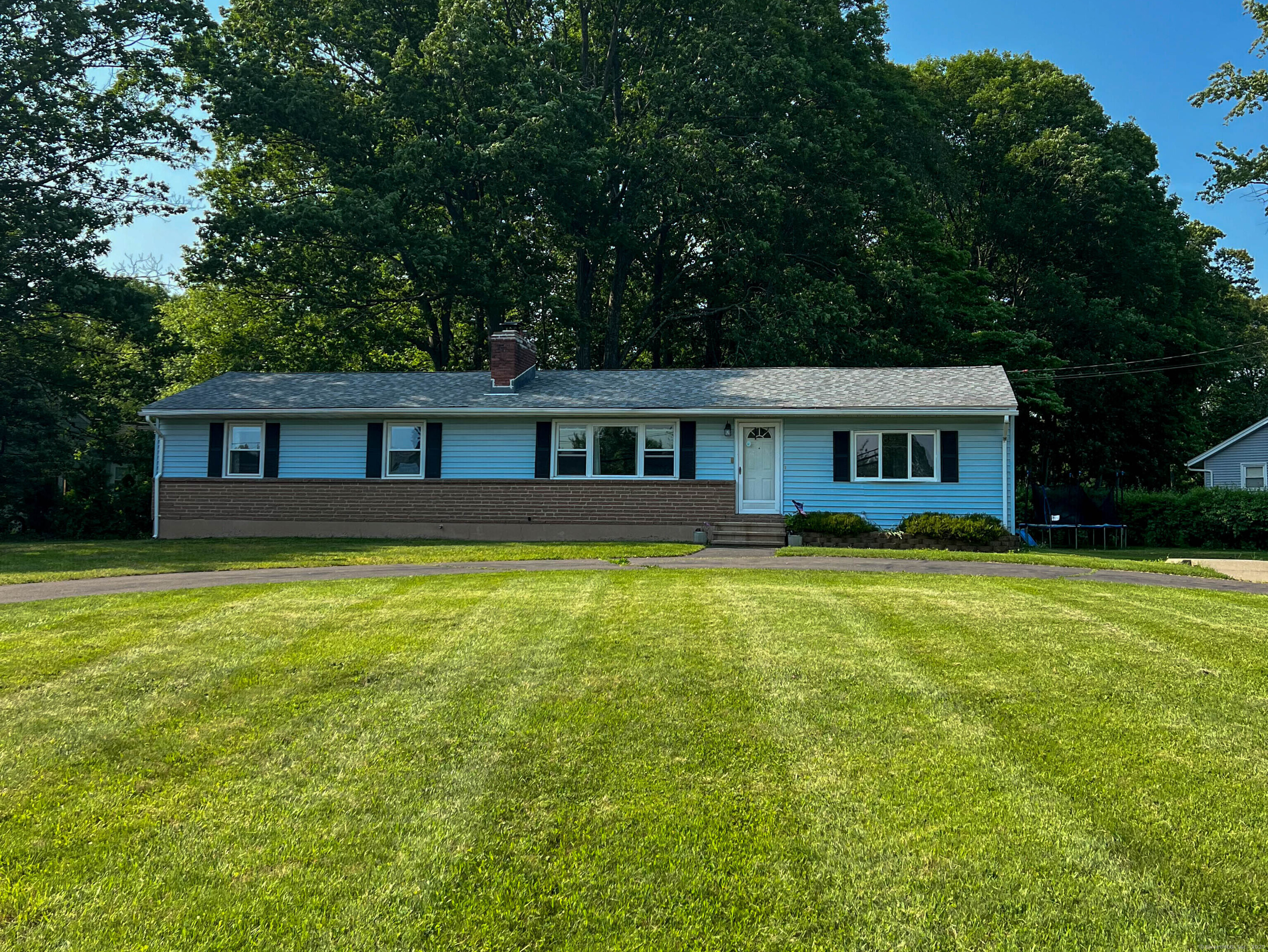 63 Ridgetop Road Wallingford, CT 06492 - Photo 1 of 1 a front view of a house with a garden and swimming pool