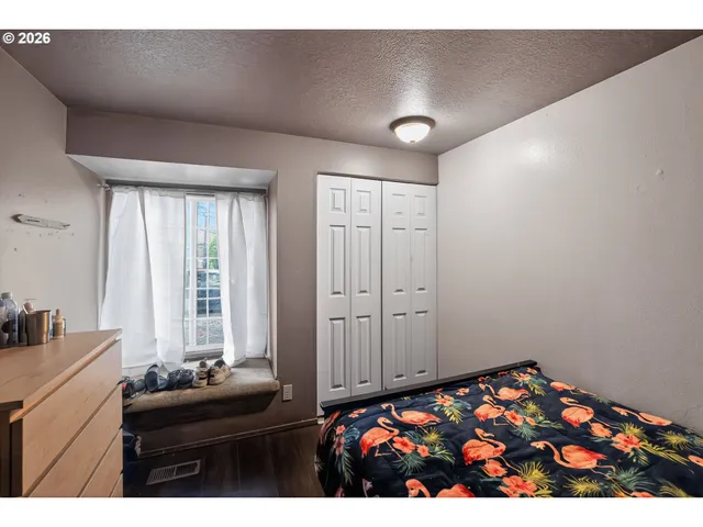 a bedroom with bed and window