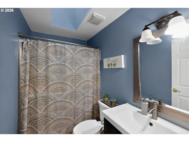 a bathroom with a sink mirror and vanity