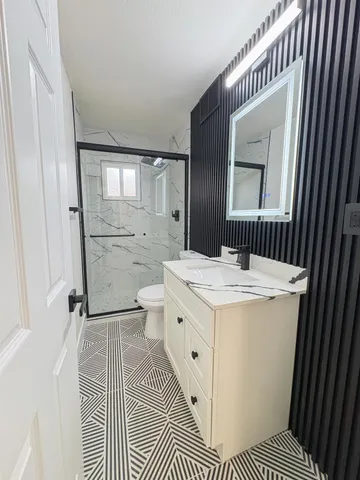 a spacious bathroom with a sink a toilet and shower