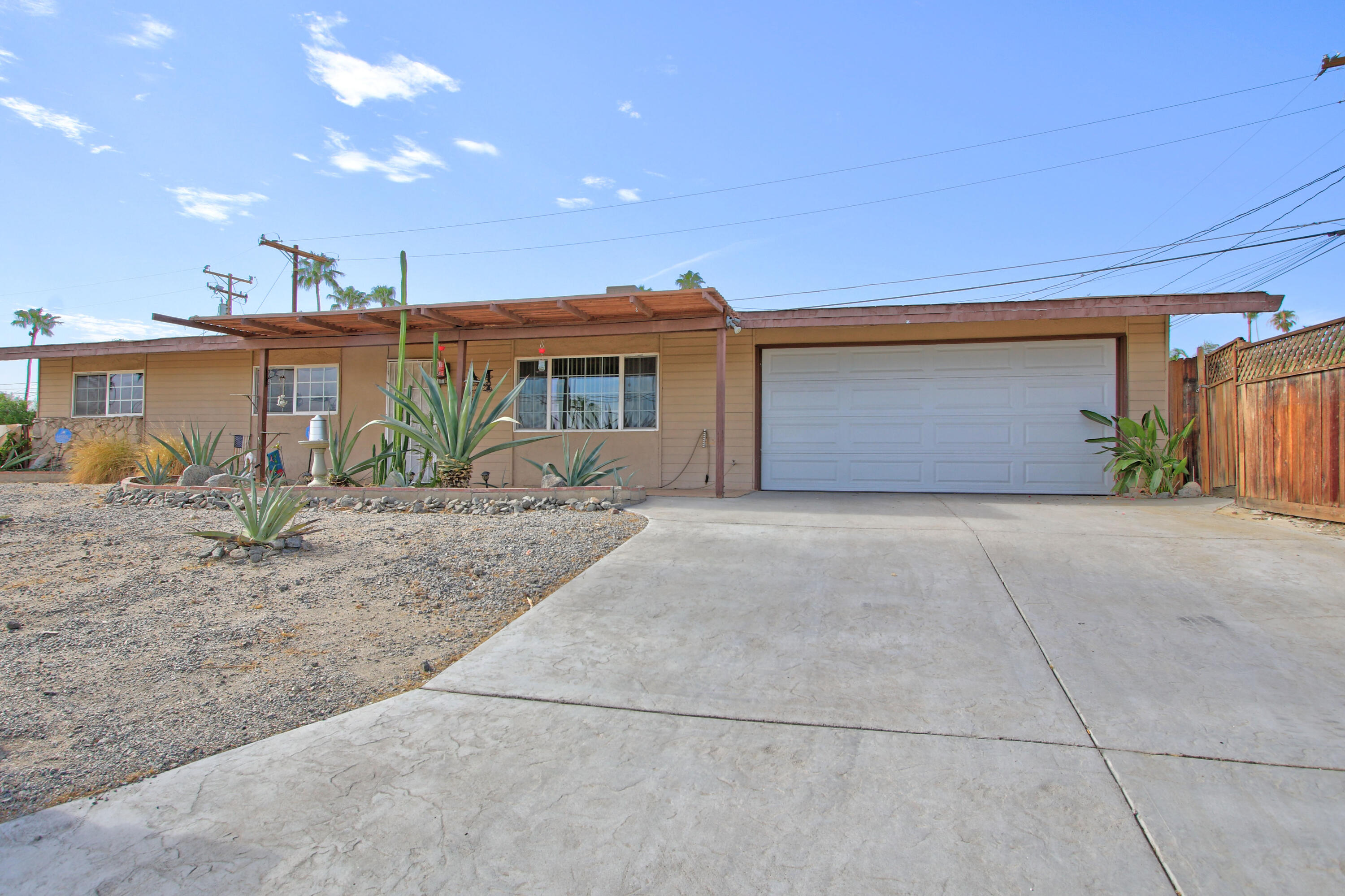 68345 Terrace Road Cathedral City, CA 92234 - Photo 1 of 36 a front view of a house with garden