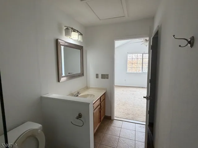 a bathroom with a toilet sink and mirror