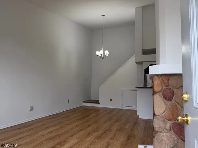 a view of a room with wooden floor and cabinets