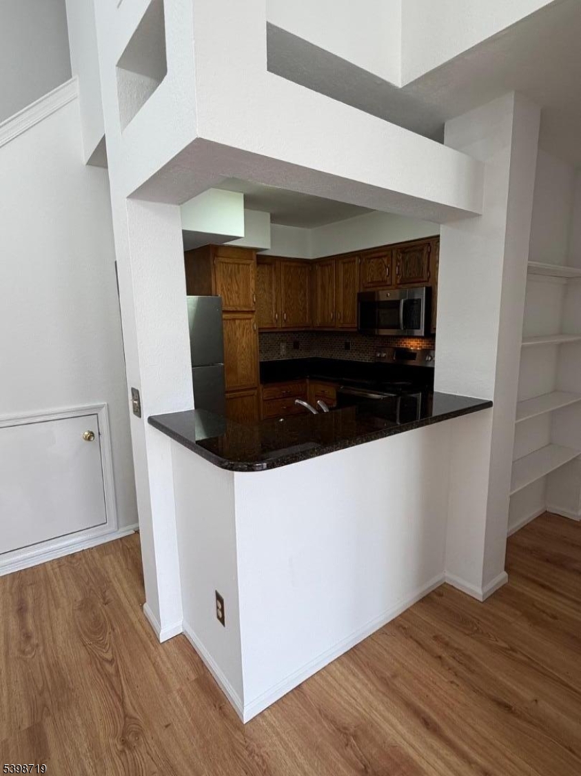 94 Wescott Road Bedminster, NJ 07921 - Photo 5 of 17 a room with wooden floor and white cabinets