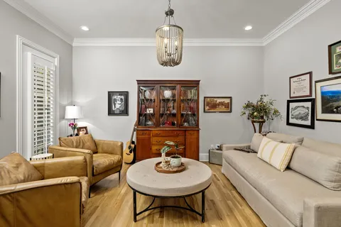 a living room with furniture a window and wooden floor