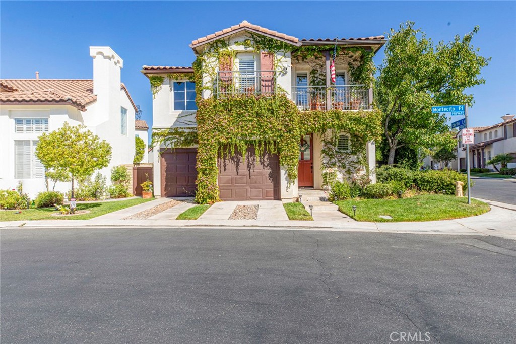 23301 Montecito Place Valencia, CA 91354 - Photo 1 of 45 a front view of a house with a yard and potted plants