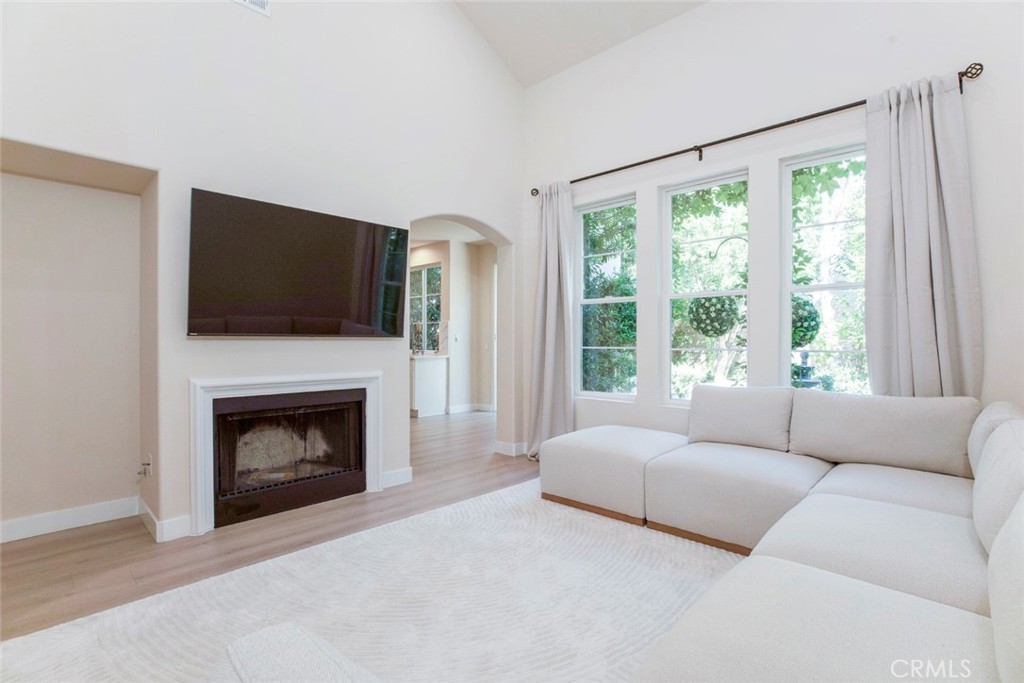 23301 Montecito Place Valencia, CA 91354 - Photo 11 of 45 a living room with furniture a flat screen tv and a fireplace