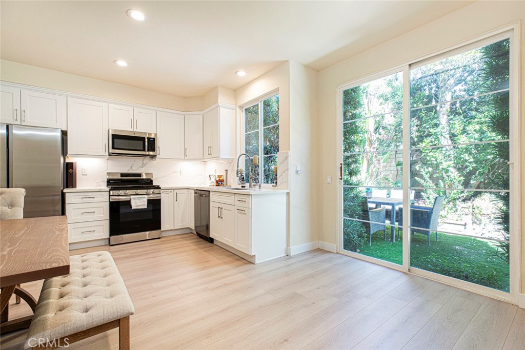 23301 Montecito Place Valencia, CA 91354 - Photo 13 of 45 a kitchen with a stove a sink and a refrigerator