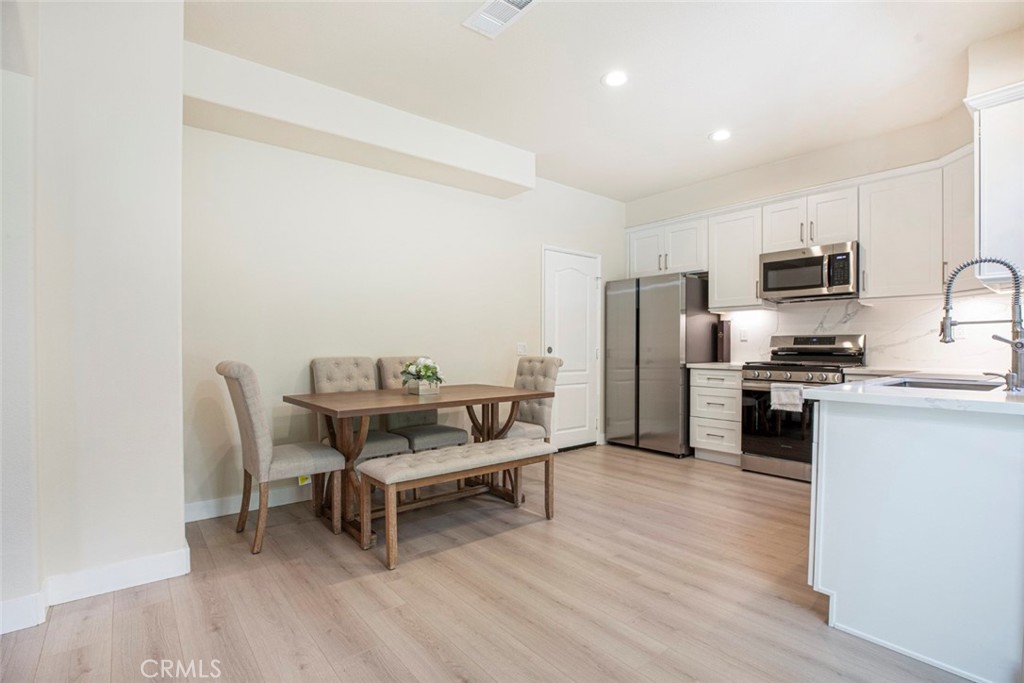 23301 Montecito Place Valencia, CA 91354 - Photo 14 of 45 a kitchen with a microwave a refrigerator and a stove top oven
