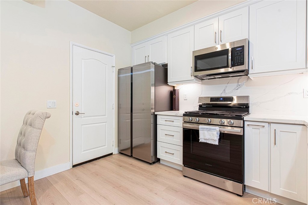 23301 Montecito Place Valencia, CA 91354 - Photo 15 of 45 a kitchen with stainless steel appliances a refrigerator stove and microwave