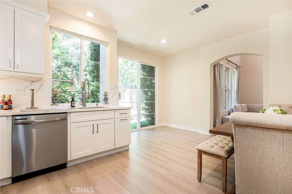 23301 Montecito Place Valencia, CA 91354 - Photo 16 of 45 a kitchen with granite countertop cabinets stainless steel appliances a sink and a window