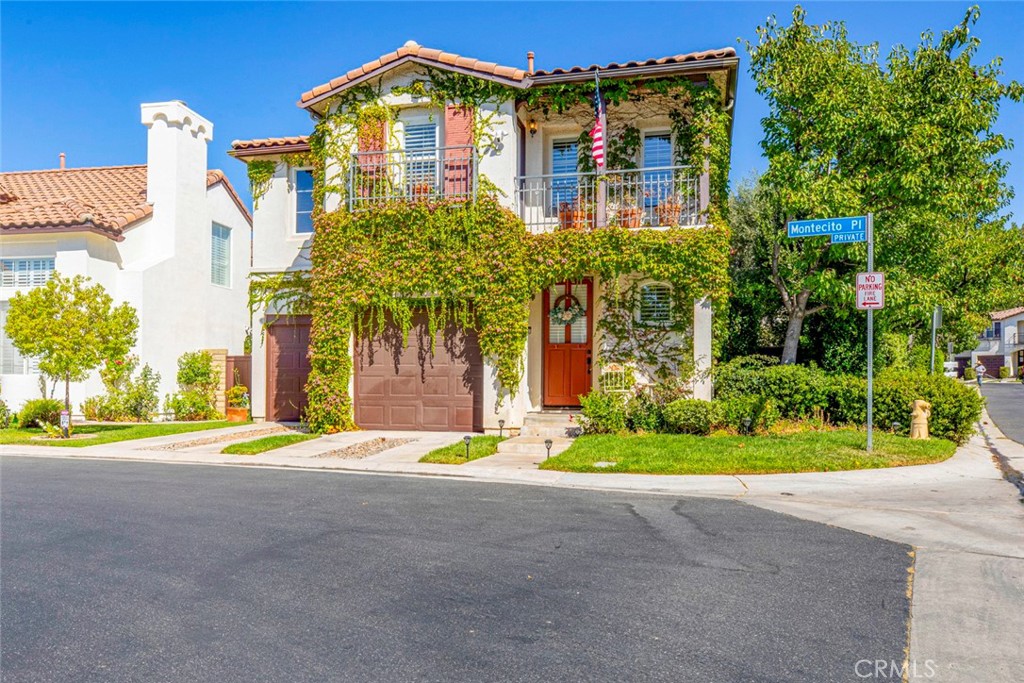 23301 Montecito Place Valencia, CA 91354 - Photo 2 of 45 a front view of a multi story residential apartment building with a yard