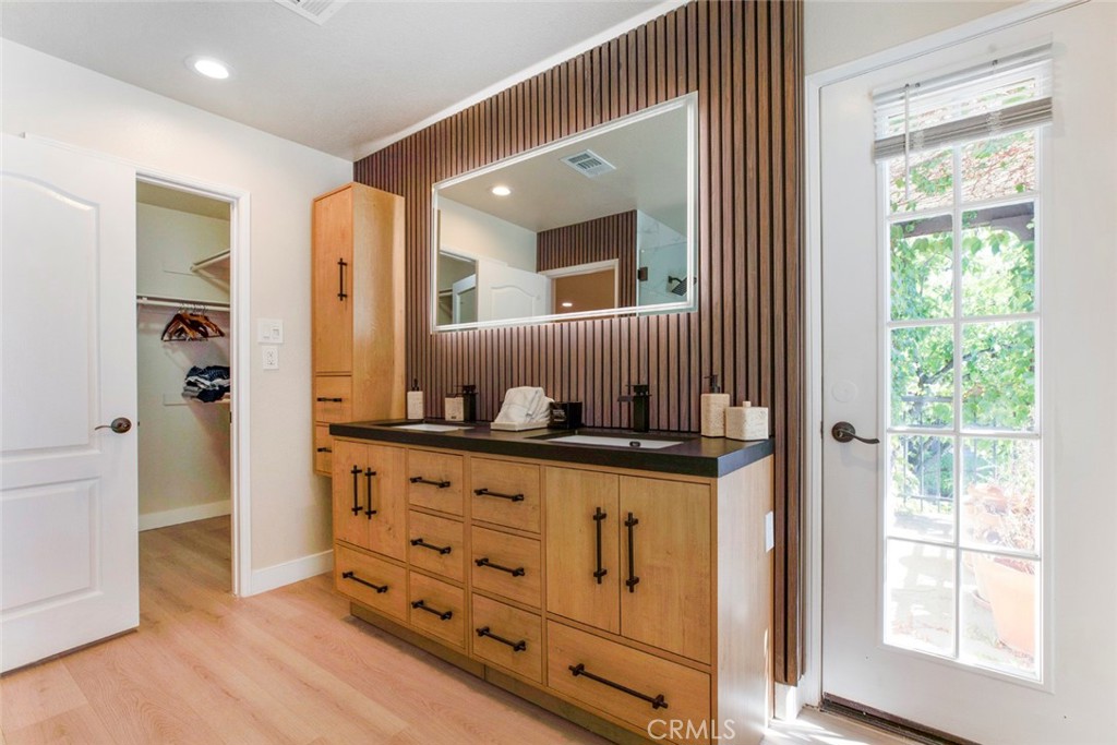23301 Montecito Place Valencia, CA 91354 - Photo 23 of 45 a bathroom with sink mirror and window