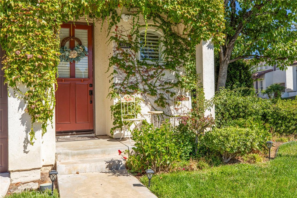 23301 Montecito Place Valencia, CA 91354 - Photo 3 of 45 a front view of a house with a yard