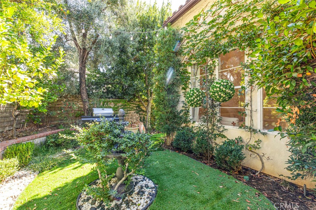 23301 Montecito Place Valencia, CA 91354 - Photo 32 of 45 a backyard of a house with lots of green space