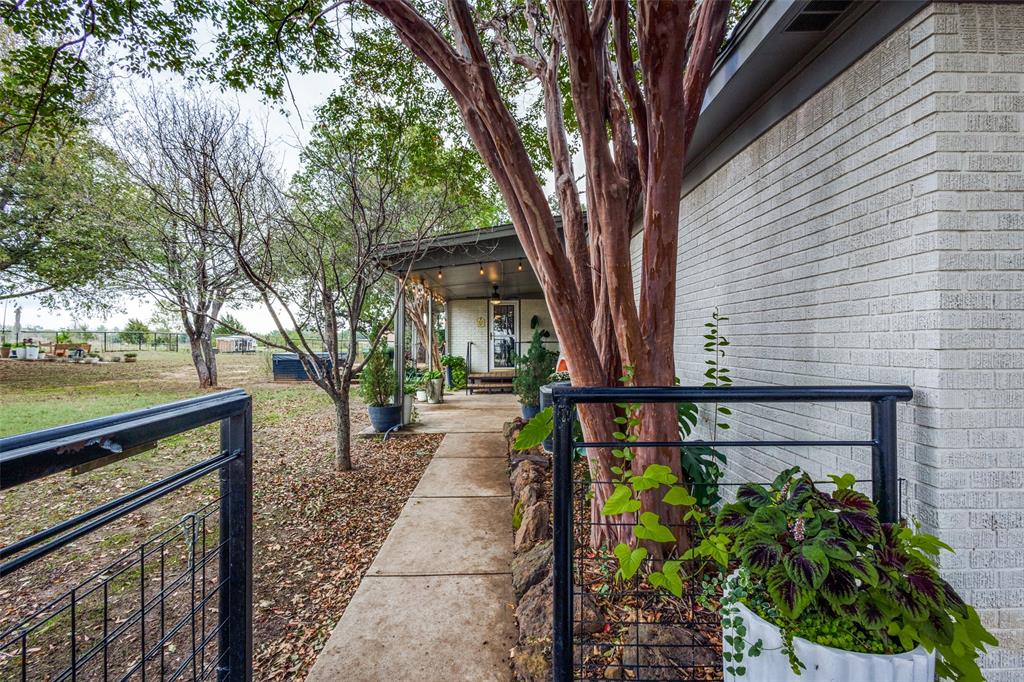 1200 Tipps Road Cross Roads, TX 76227 - Photo 25 of 32 a front view of a house with garden