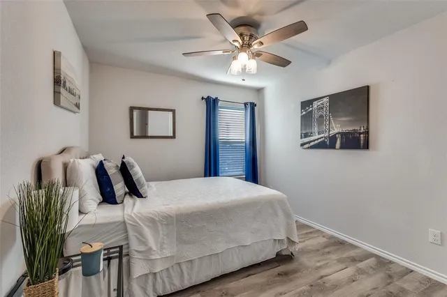 a bedroom with a large bed and a chandelier