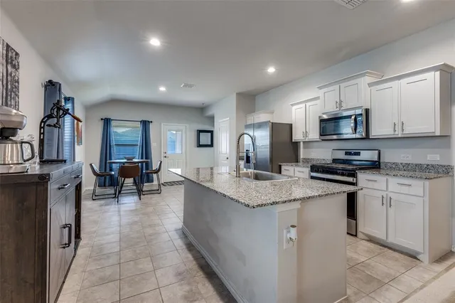 a kitchen with counter top space cabinets and appliances