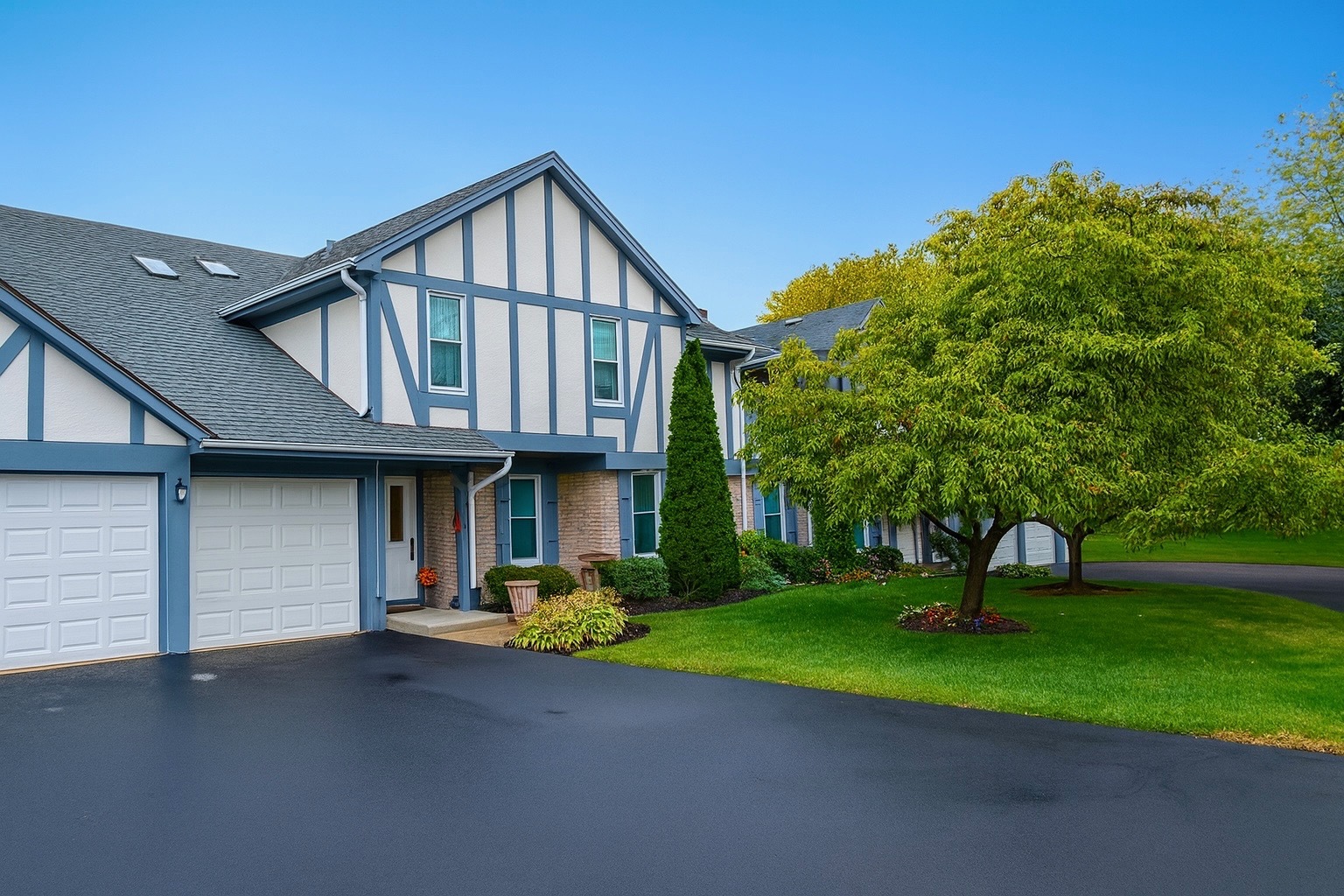 36 West Fern Court, Unit 117B Palatine, IL 60067 - Photo 1 of 11 a front view of house with yard and green space