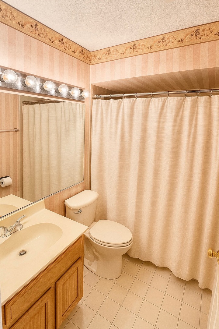 36 West Fern Court, Unit 117B Palatine, IL 60067 - Photo 7 of 11 a bathroom with a sink and a mirror
