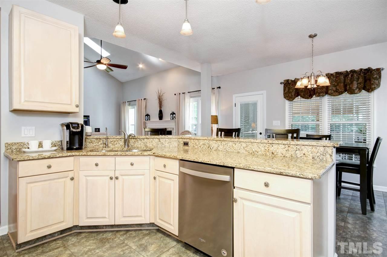 12305 Amoretto Way Raleigh, NC 27613 - Photo 6 of 30 Newly painted interior with updated kitchen featuring granite countertops, tile back splash, coveted light cabinets & stainless steel appliances.