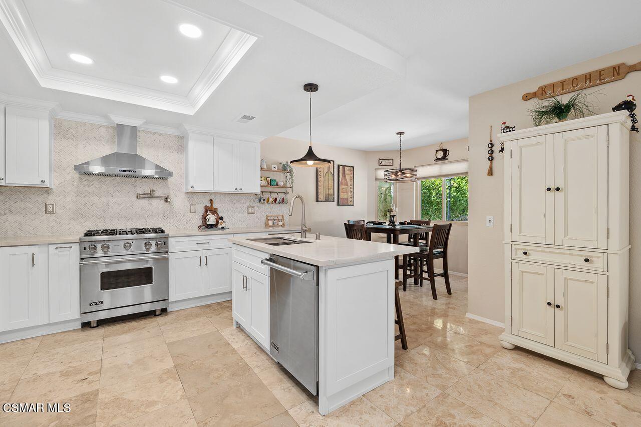 885 Congressional Road Simi Valley, CA 93065 - Photo 21 of 44 a kitchen that has a lot of white cabinets and stainless steel appliances