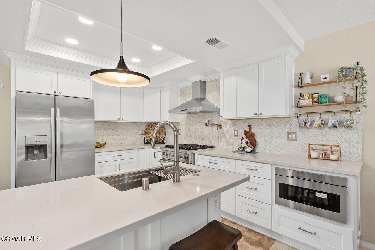 885 Congressional Road Simi Valley, CA 93065 - Photo 23 of 44 a kitchen with stainless steel appliances a sink a stove a refrigerator and cabinets