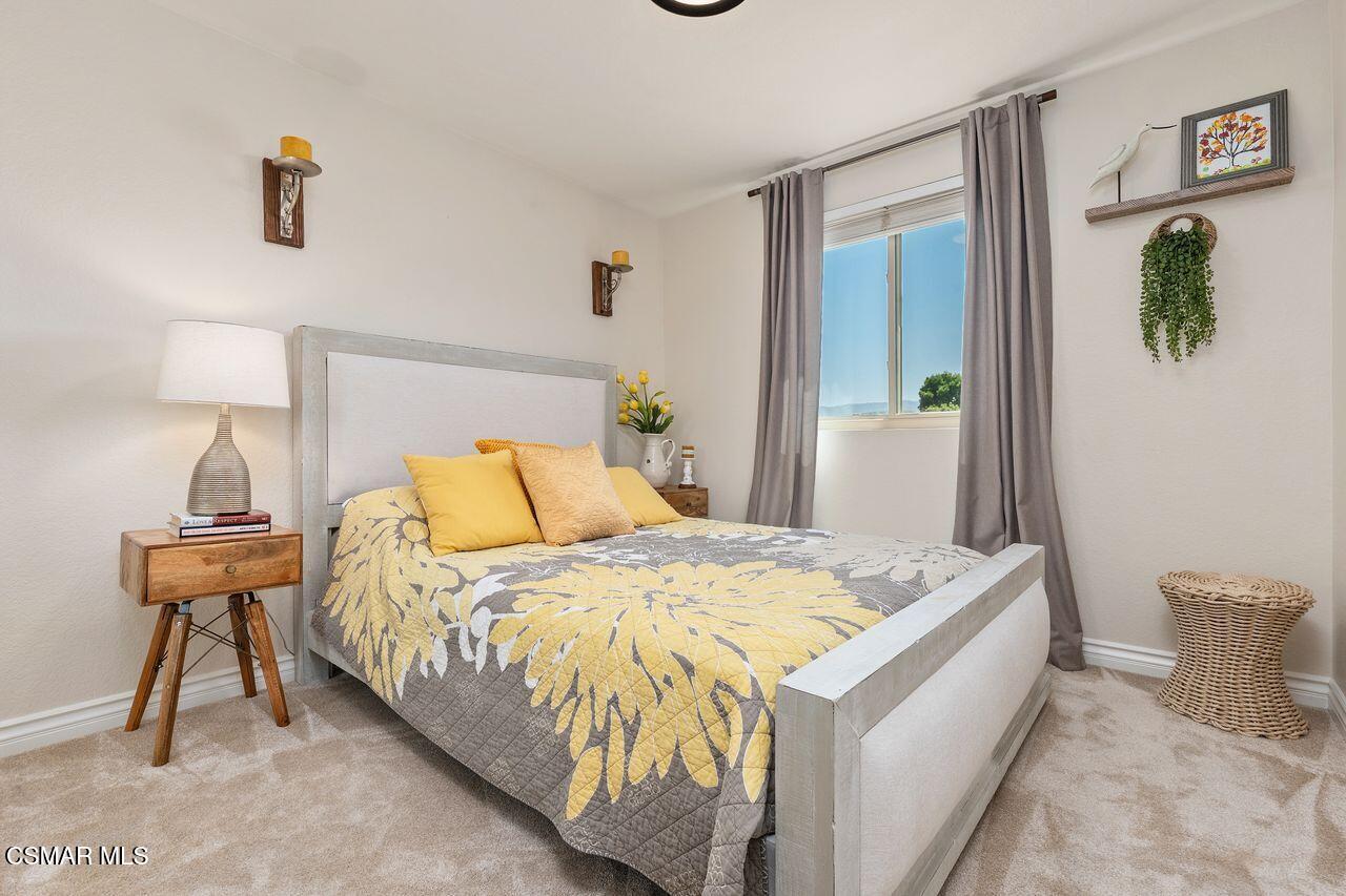 885 Congressional Road Simi Valley, CA 93065 - Photo 26 of 44 a bedroom with a bed and a table in it